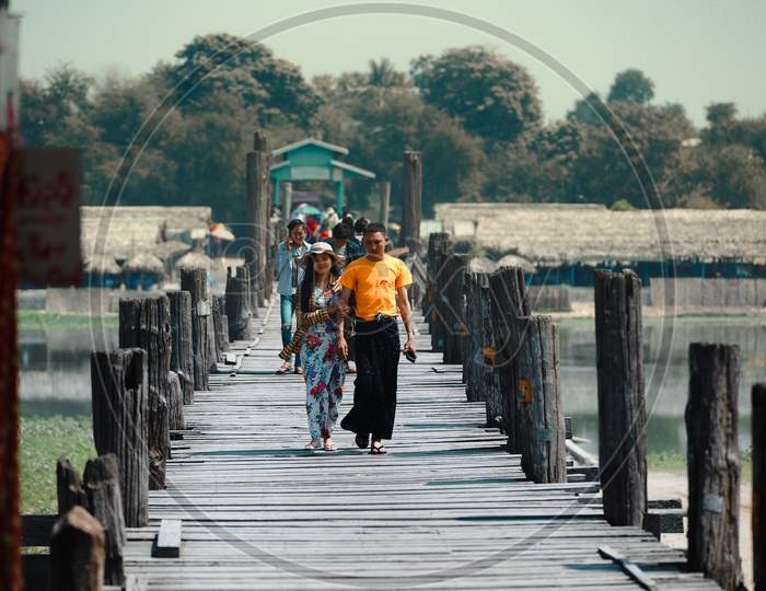People walking on a Wooden Bridge