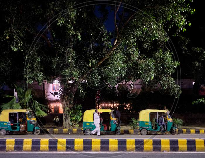 Tuk Tuks Parked In The Street In New Delhi, India, At Night