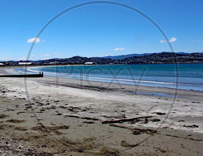 The Sea Laps Gently On The Sandy Beach At Lyall Bay Near Wellington In New Zealand