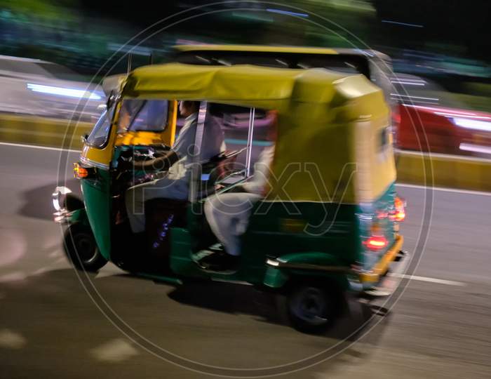 Tuk Tuk In Motion Driving In The Streets Of New Delhi, India, At Night