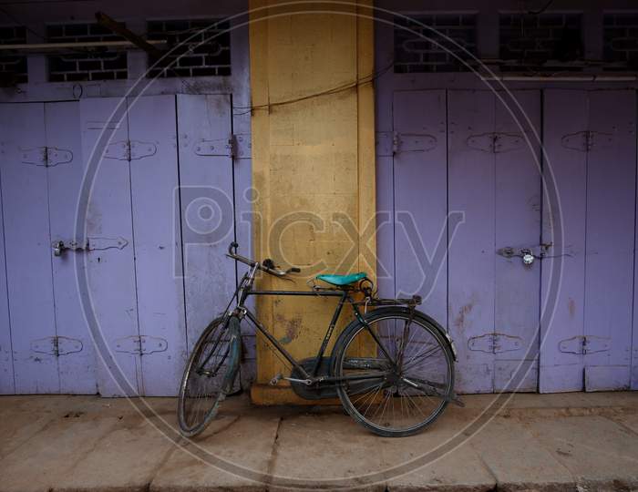 A bicycle is propped against shuttered shops during the nationwide lockdown to stop the spread of Coronavirus (COVID-19) in Bangalore, India, May 01, 2020.