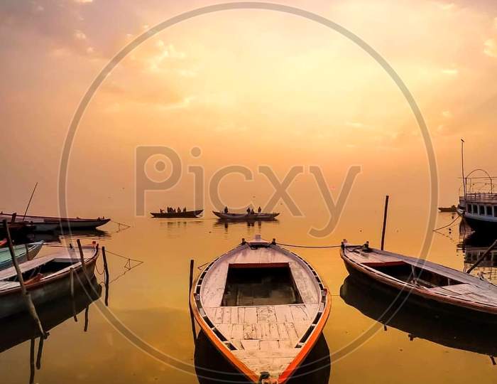 Sunset view of boats on shore for trading