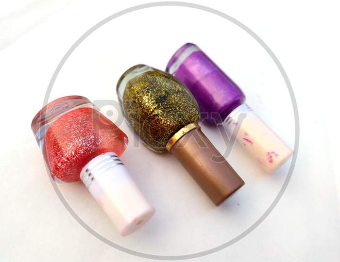 colorful nail polish glass bottle isolated on white background