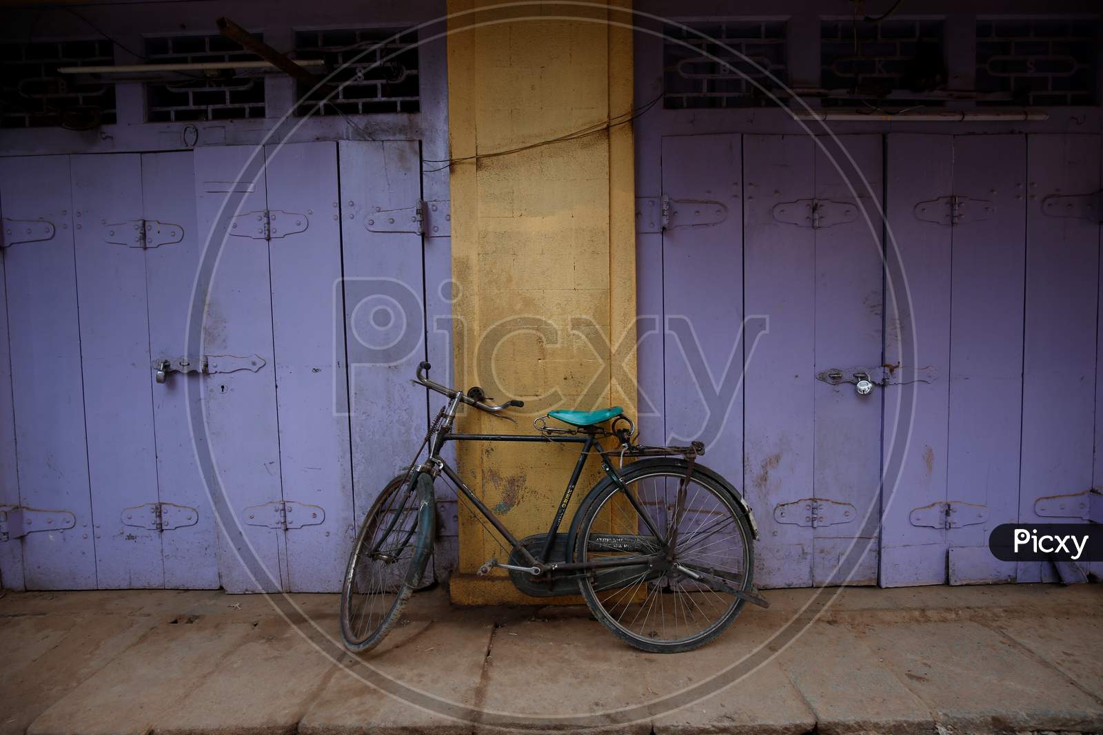 A bicycle is propped against shuttered shops during the nationwide lockdown to stop the spread of Coronavirus (COVID-19) in Bangalore, India, May 01, 2020.