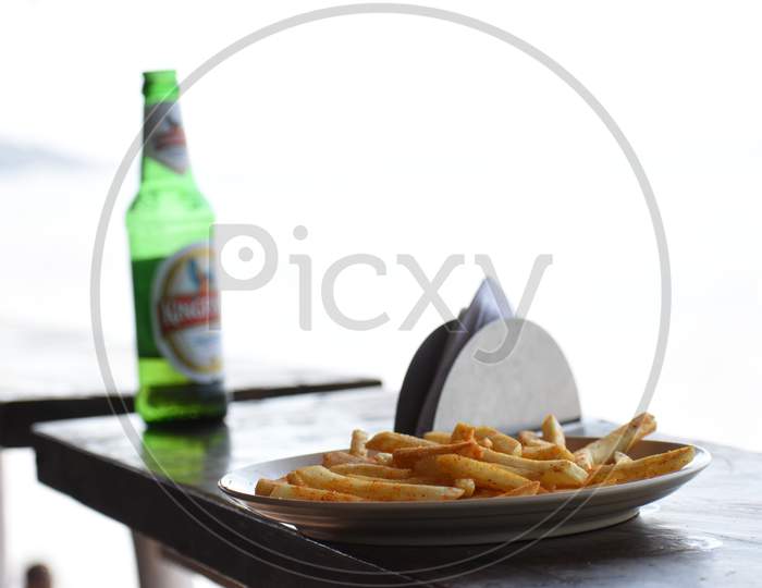 Beer And French Fries In Beach Background.