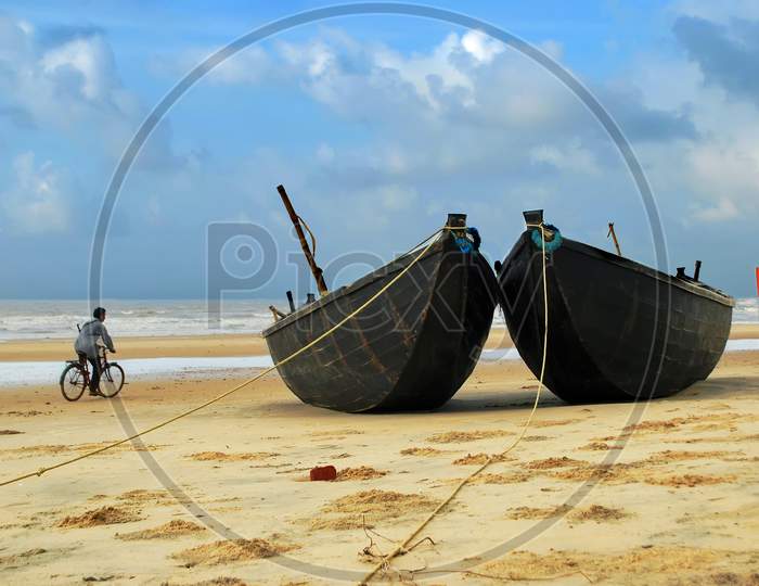 cycle and boats at mandermoni sea beach abstract or conceptual photography.