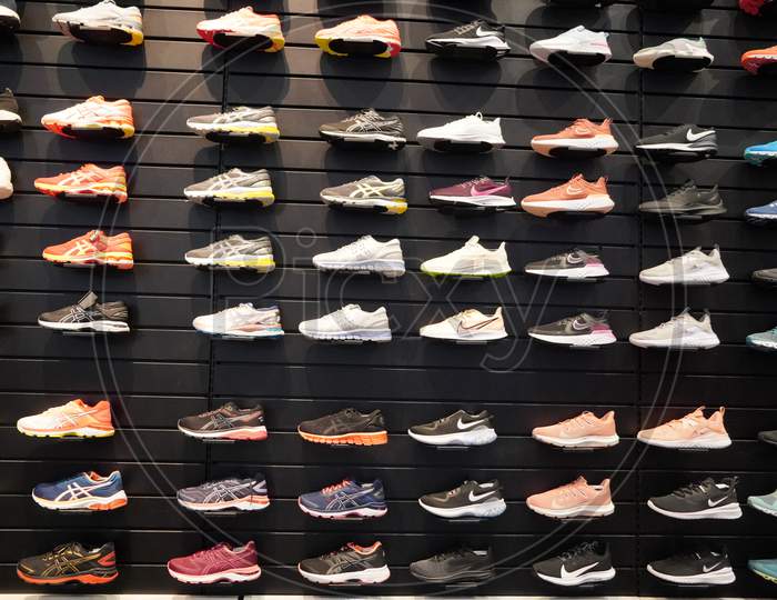 Image of Shop Display Of A Lot Of Sports Shoes On A Wall. A View Of A ...