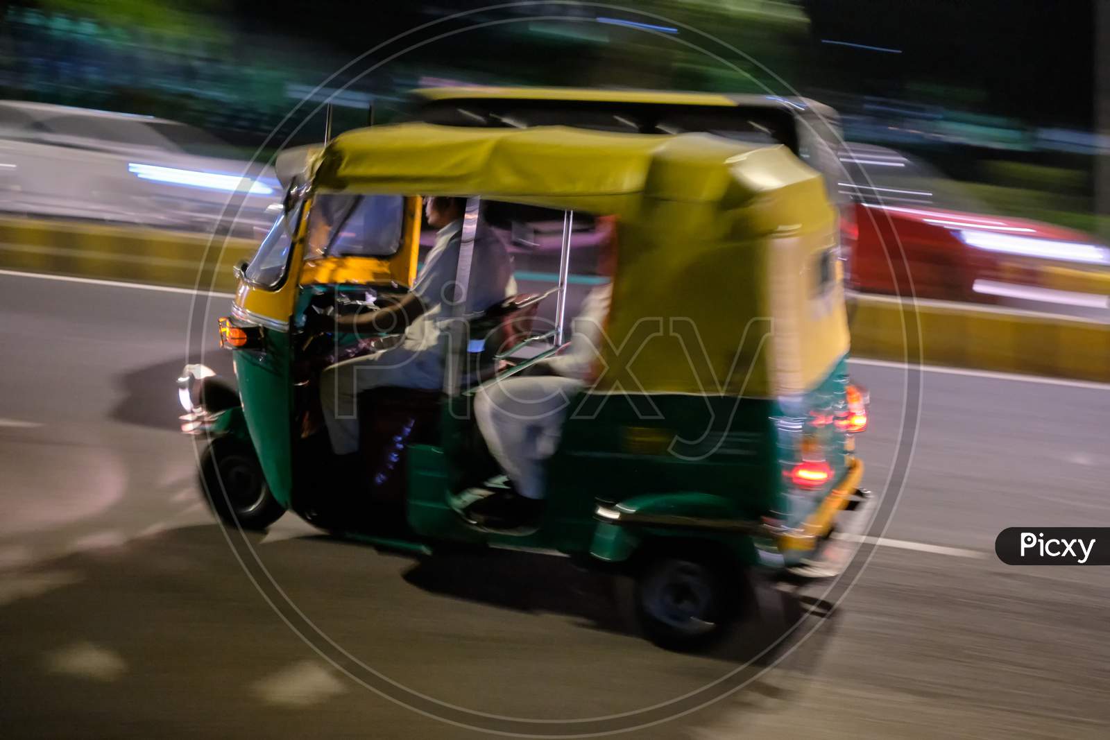 Tuk Tuk In Motion Driving In The Streets Of New Delhi, India, At Night