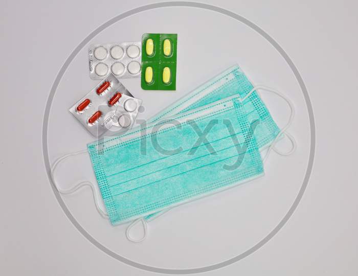 Protective Medical Masks or Disposable Surgical Face Mask with Tablets Isolated On White Background