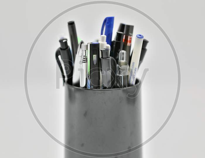 Set of Pens in a Pen Holder with White Background