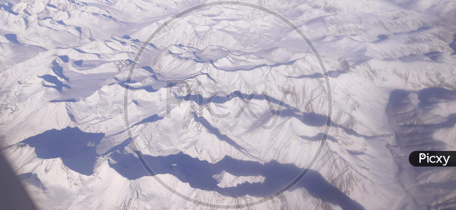 A view of the Ladakh Range of mountains as seen from a flight in winter, while landing at Leh, India