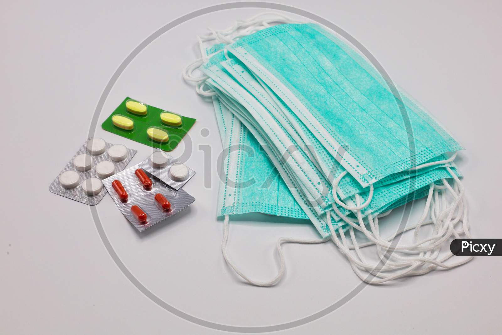 Protective Medical Masks or Disposable Surgical Face Mask with Tablets Isolated On White Background