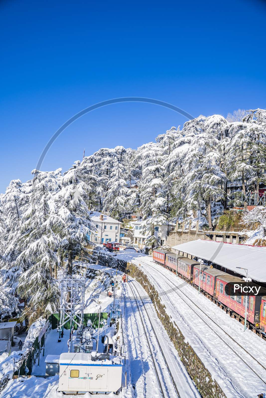 Snowfall View moving train on mountain slopes, beautiful view, one side mountain, one side valley. Toy train from Shimla to Kalka
