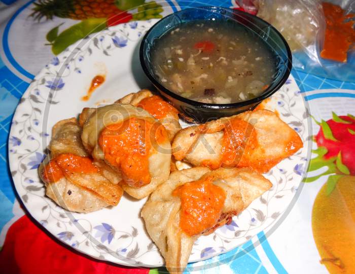 One dish of indian food momos tasty and crunchy. With chicken soup