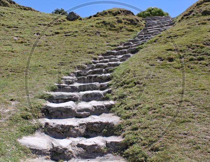 Stone Steps Cut Into A Grassy Bank Lead Up The Hillside To The Summit.
