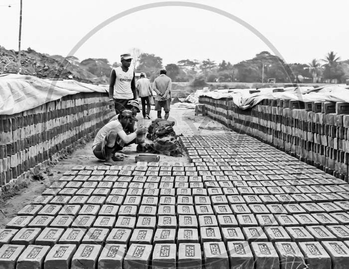 Workers are making bricks with soft soil