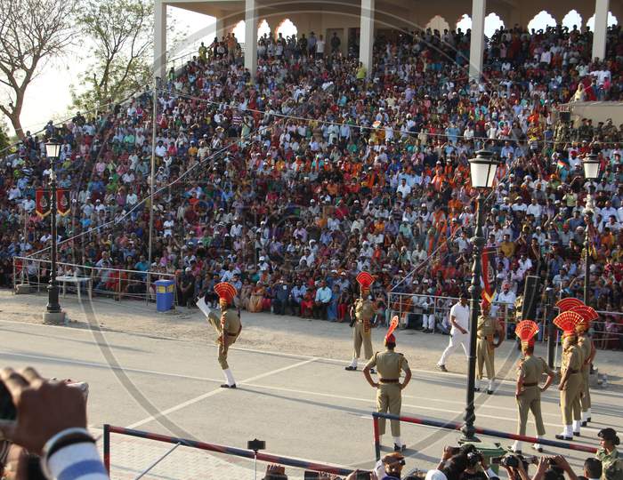 Indian crowd cheering and celebrating Border Security Force of Indian Army at Wagha Border, India.