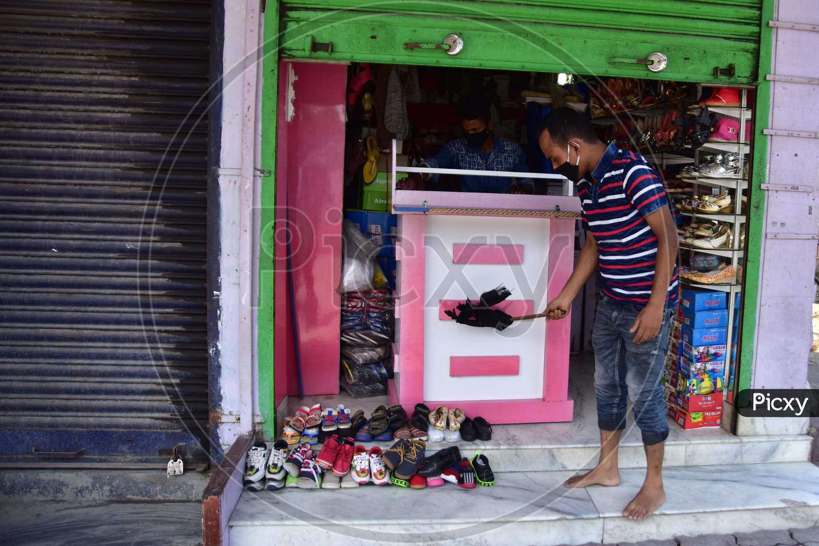 Nagaon :A  Shopkeeper Clean His  Shoe  Shop After Authorities Allowed Sale  With Certain Restrictions, During The Ongoing Covid-19 Nationwide Lockdown In Nagaon District Of Assam On May 04,2020 .Pix By Anuwar Hazarika