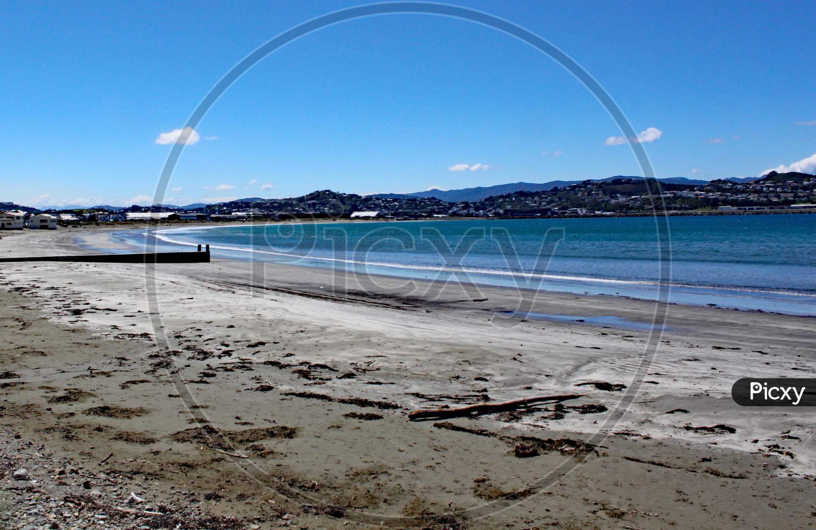 The Sea Laps Gently On The Sandy Beach At Lyall Bay Near Wellington In New Zealand