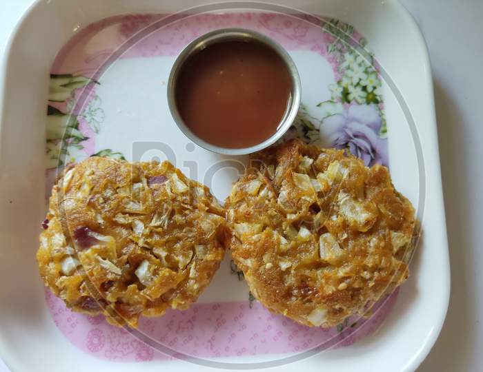 Cabbage cutlets in a plate. Cutlets plate on plain background. Veg cutlet receipe with tomato ketchup.