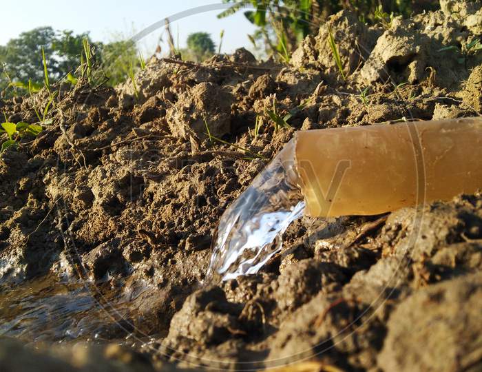 Water is coming through a plastic pipe in agriculture land