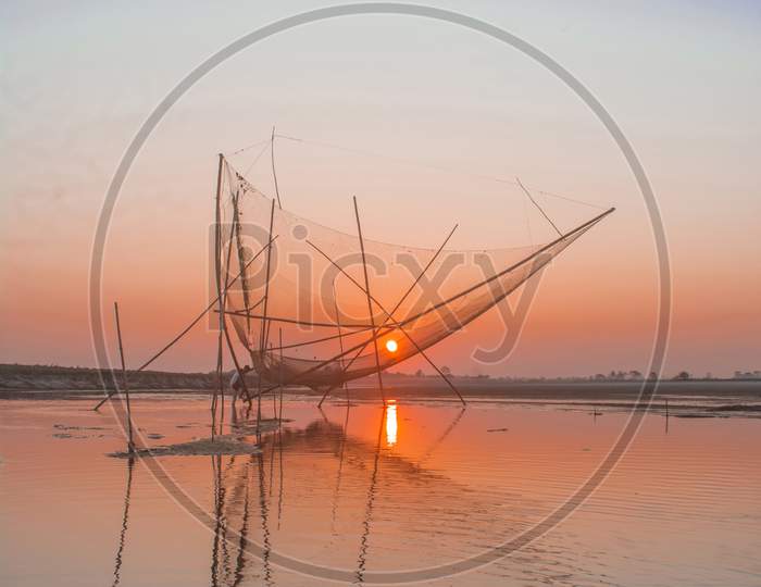 Fishing net during Sunset at the river Brahmaputra in Majuli Island, Assam.