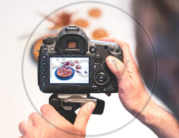Man capturing photo with camera of food