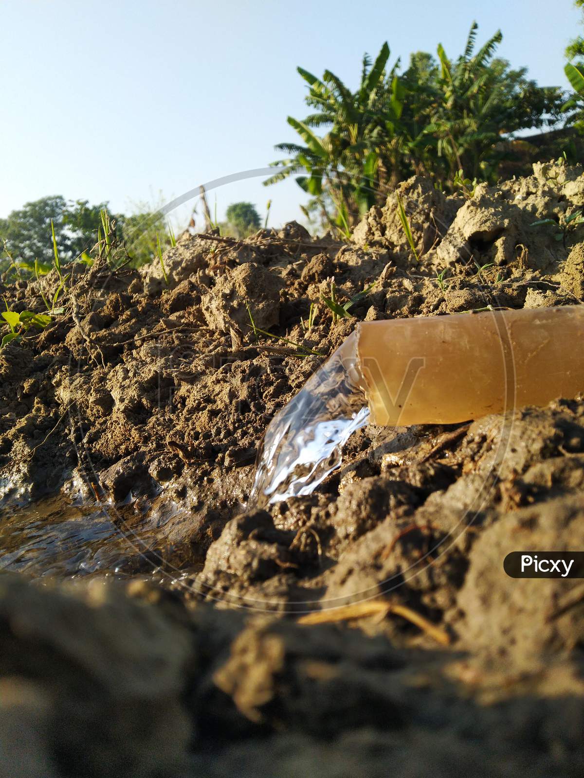 Water is coming through a plastic pipe in agriculture land