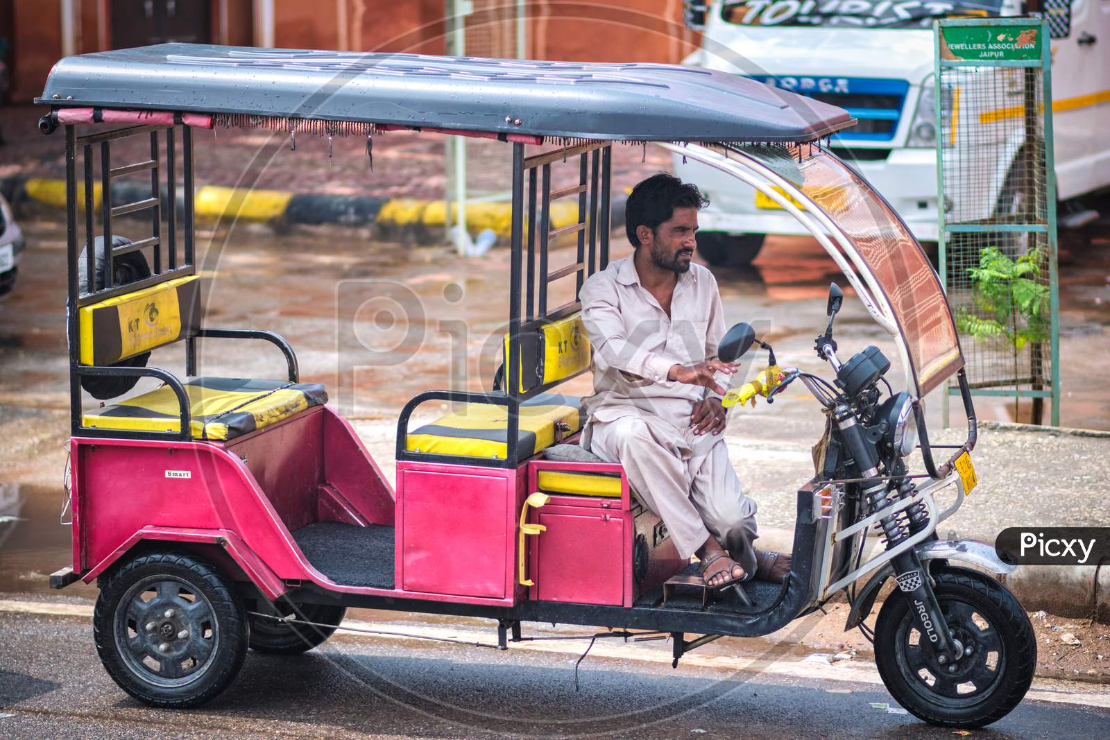 Driver Sitting In His Tuk Tuk, Waiting For Customers In Jaipur, Rajasthan, India