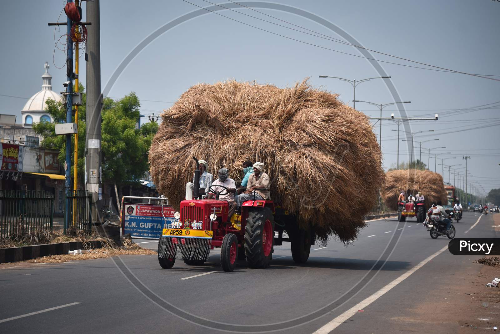 Farmers Carry A Pile Of Paddy Straw Loaded On A Tractor During The Nationwide Lockdown, Imposed In The Wake Of Coronavirus Pandemic, In Gannavaram.