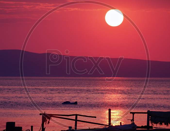 Late evening sunset scenery with lonely boat in Kampor bay, island Rab, Croatia