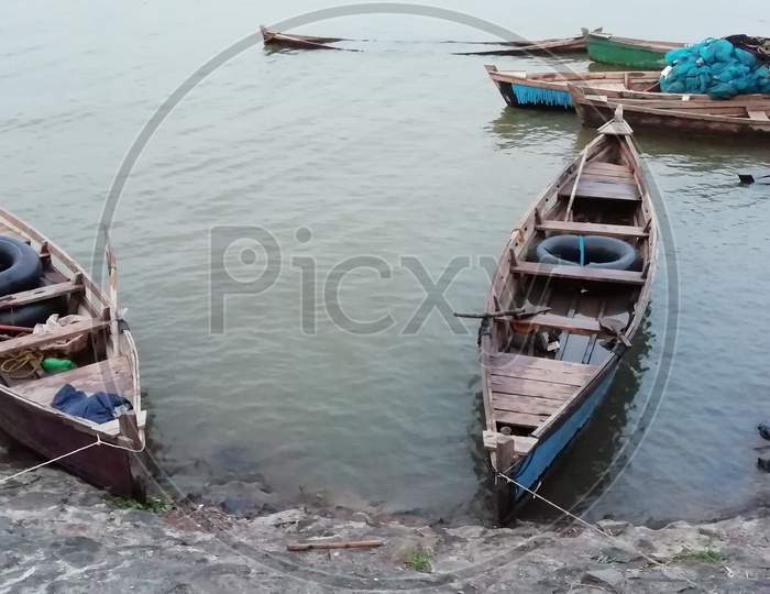 Two wooden boats on coast