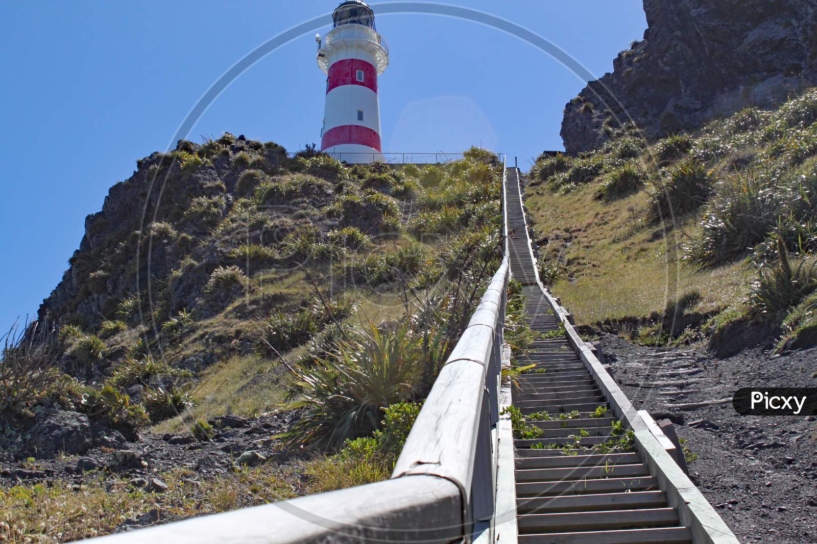 250 Steps Lead Up To The Red And White Striped Lighthouse At Cape Palliser On North Island, New Zealand. The Lighthouse Was Built In 1897 And Was Originally Fueled By Oil.