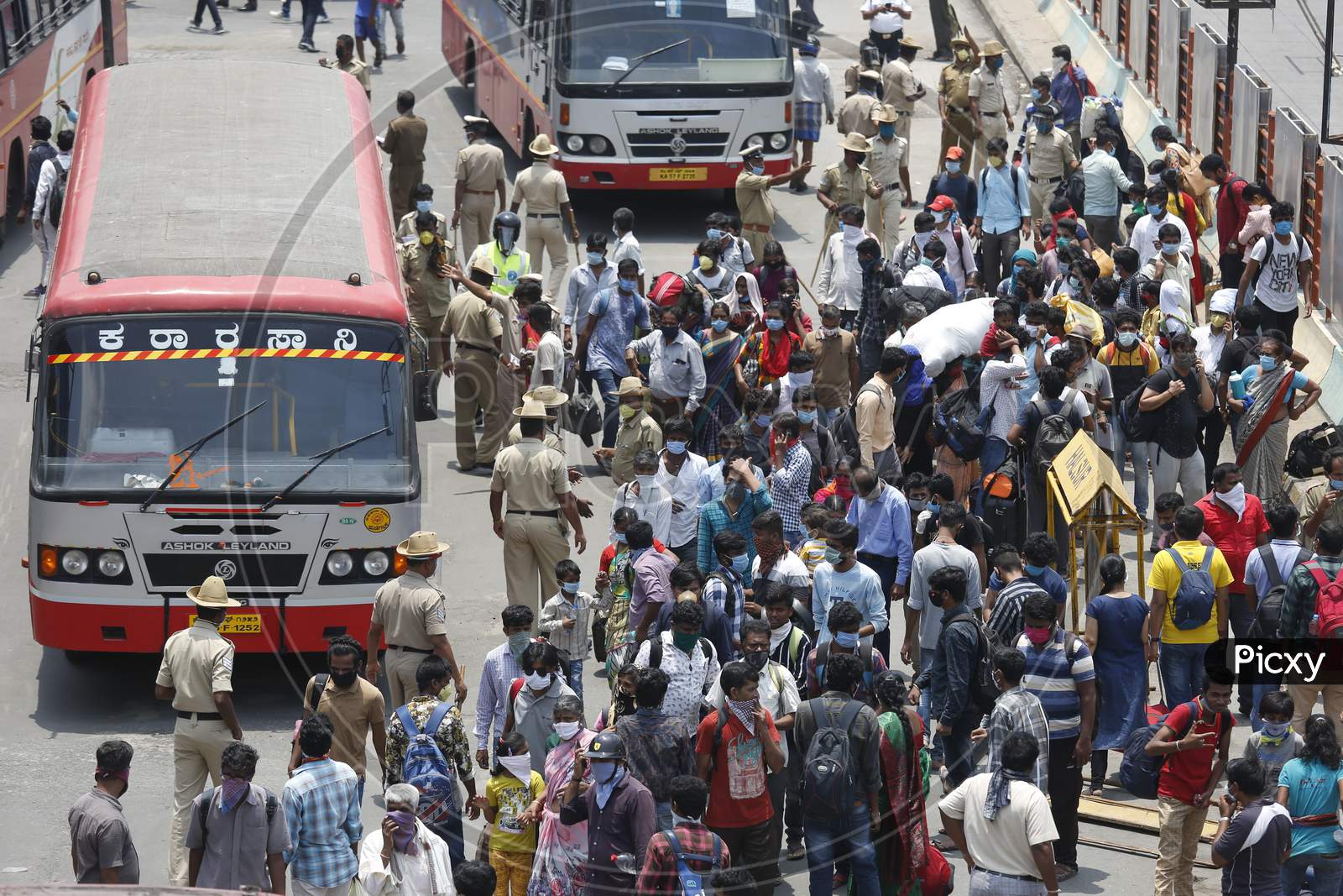 People walk to board public transport buses during the nationwide lockdown to stop the spread of Coronavirus (COVID-19) in Bangalore, India, May 03, 2020.