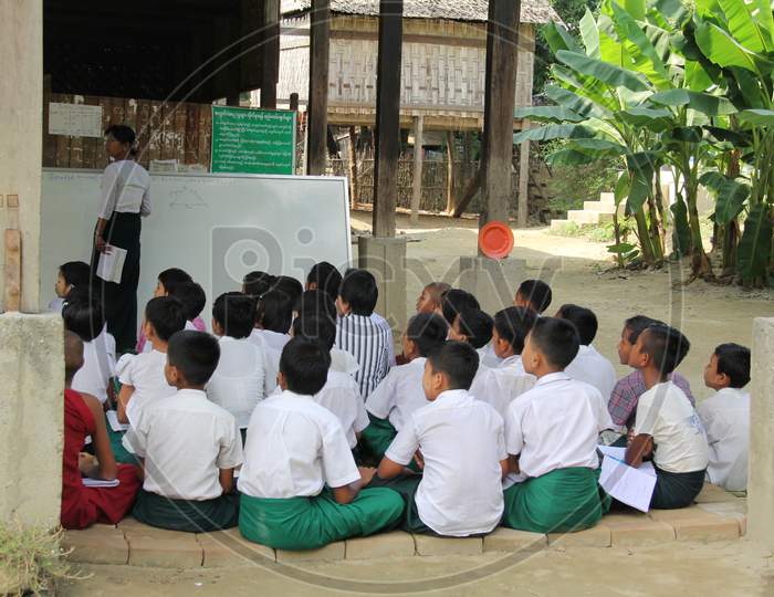 SAGAING, MYANMAR - JANUARY 27, 2014: Unidentified Burmese girls and boys in a local school during the lesson.