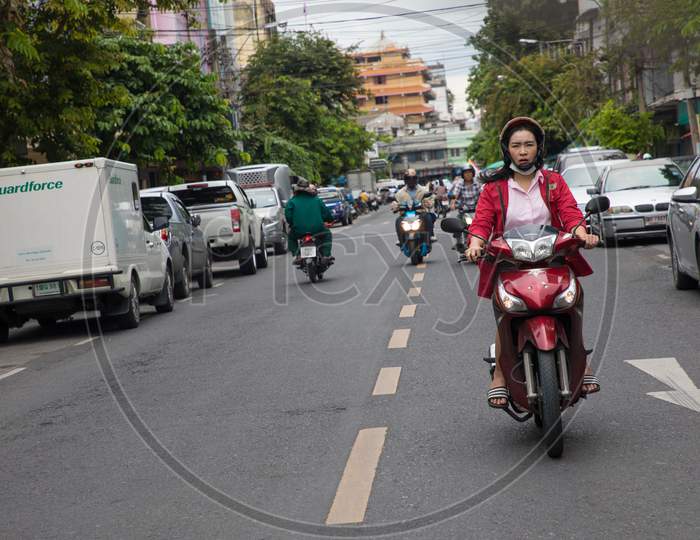 People moving on Roads on Scooters