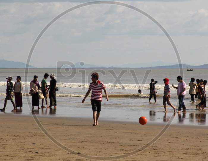 People Playing on the Seashore