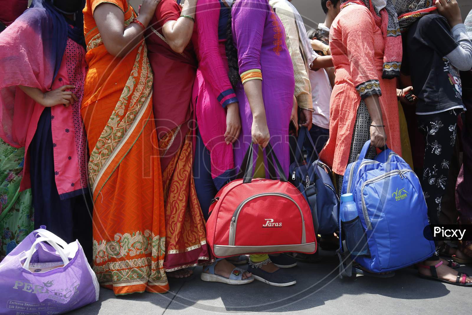 People wait in a queue to board public transport buses during the nationwide lockdown to stop the spread of Coronavirus (COVID-19) in Bangalore, India, May 03, 2020.