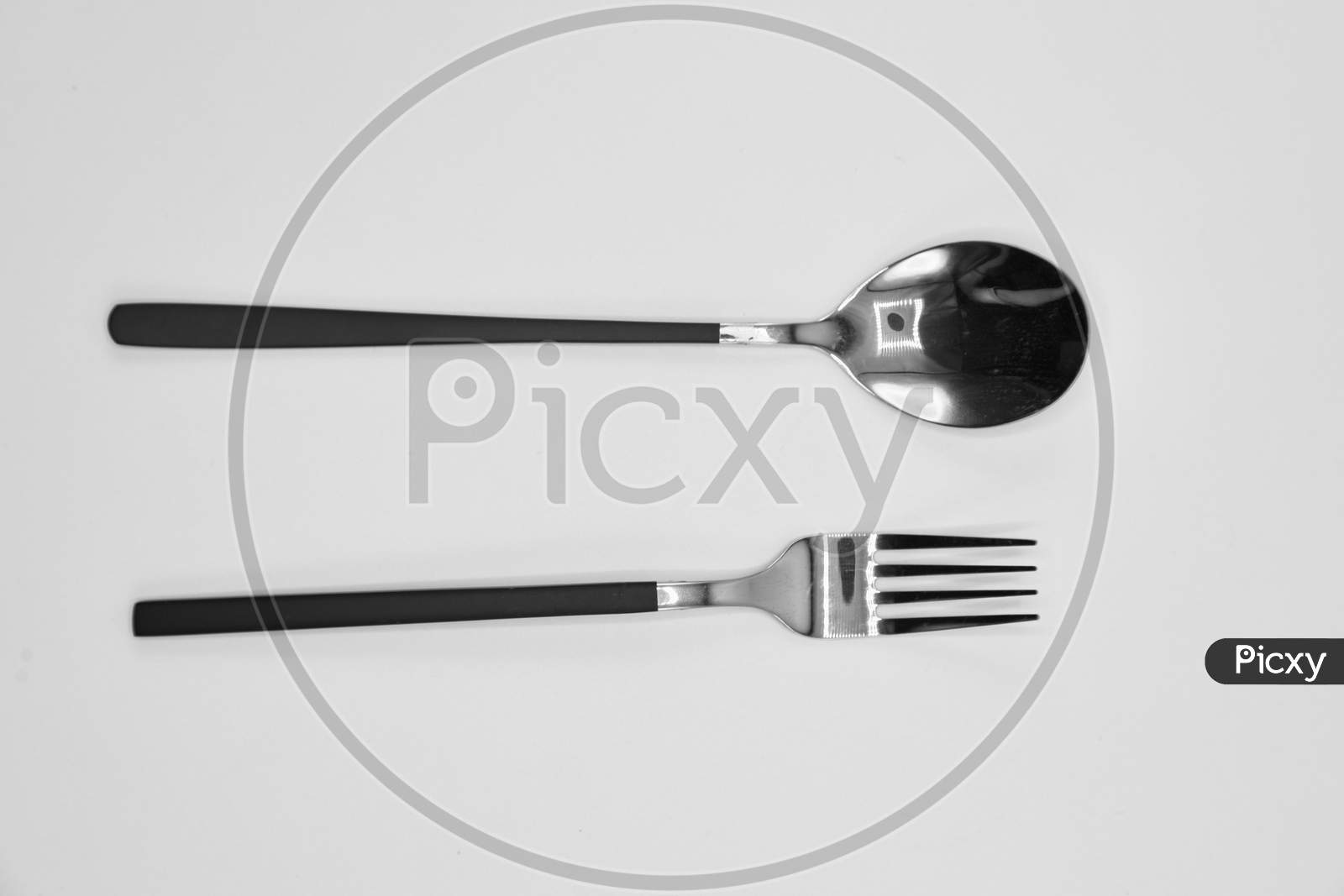 A spoon and fork in a white sheet