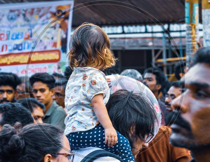 street photo of a foreign family during thrissur pooram