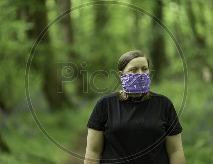 Young women wearing a handmade face mask during Coronavirus pandemic in the UK.