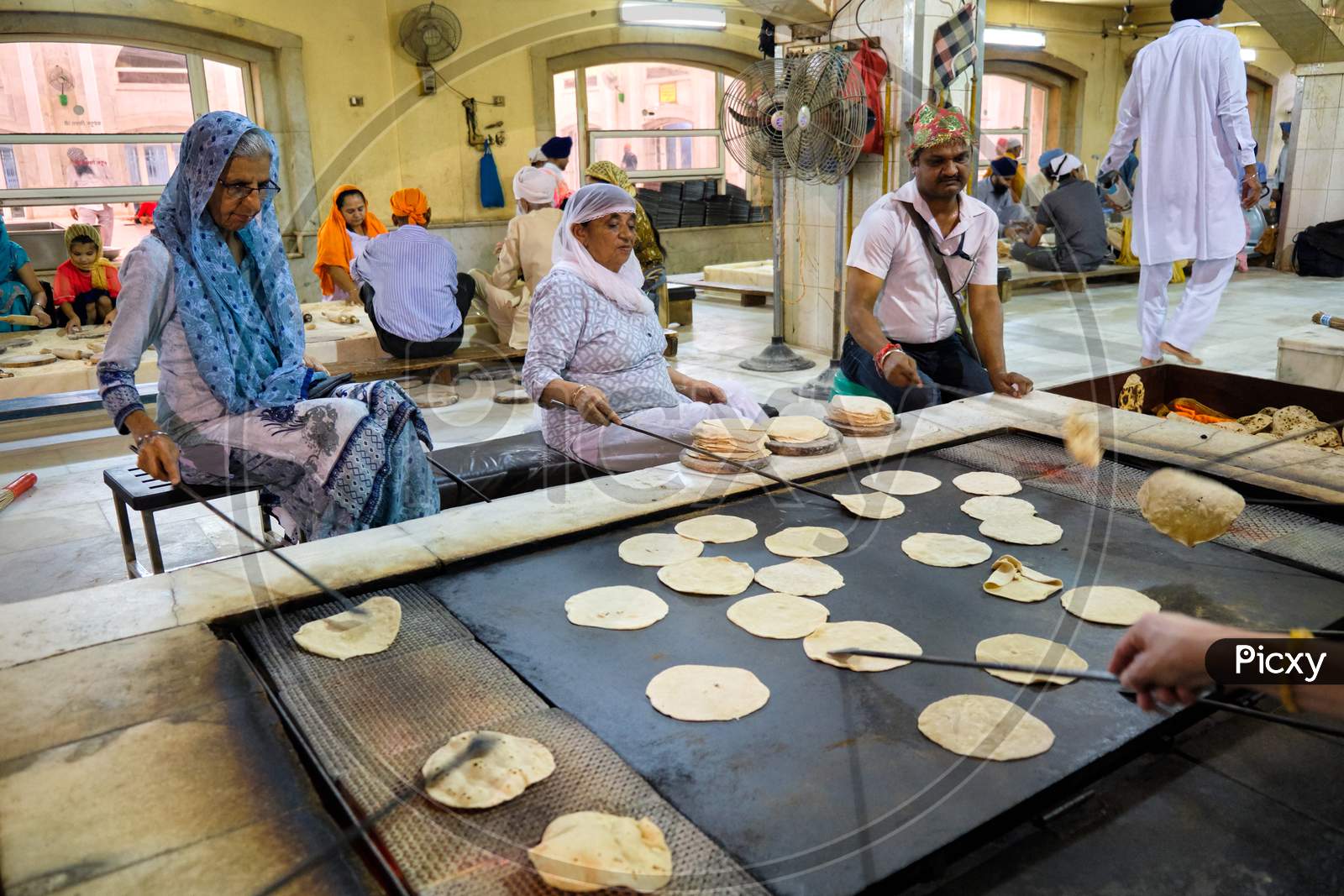 Volunteers Preparing Free Food For Visitors In The Gurdwara Community Kitchen (Langar Hall) Of Sri Bangla Sahib Gurudwara Sikh Temple, New Delhi, India