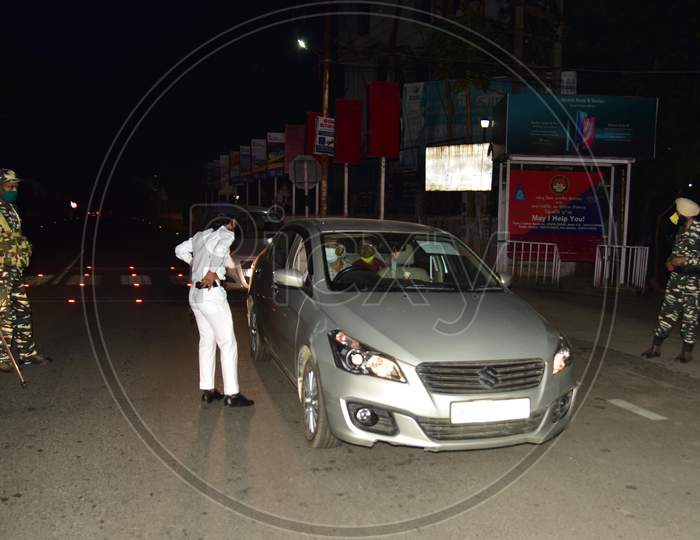 Nagaon :Security Personnel Question Commuters Who Defied Curfew In The Third Phase Of Covid-19 Lockdown, In Nagaon District Of Assam On May 04,2020.In Assam In Terms Of The Curfew Period Advanced By An Hour  From 6 Pm To 6 Am.Pix By Anuwar Hazarika