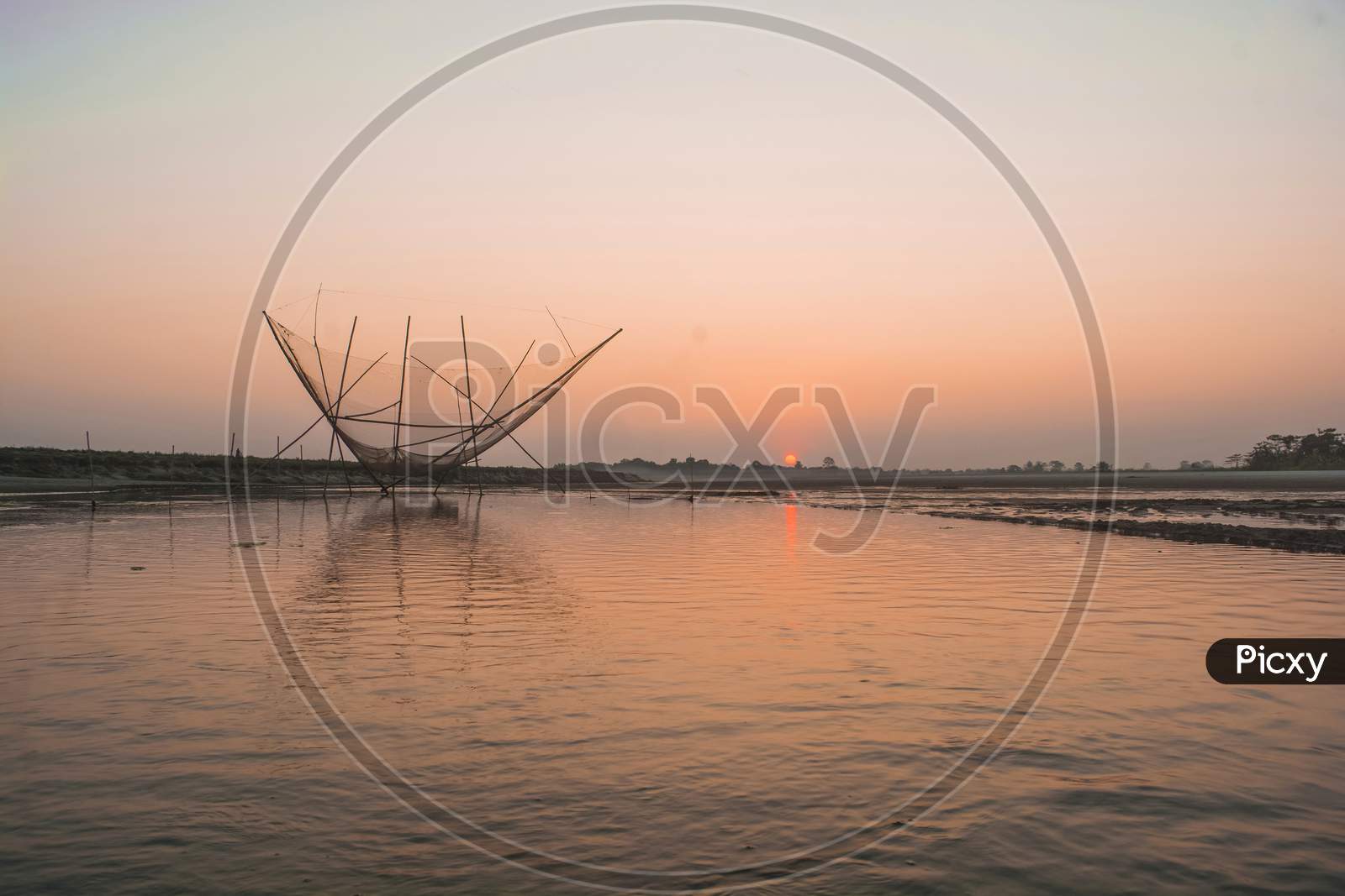 Fishing net during Sunset at the river Brahmaputra in Majuli Island, Assam.