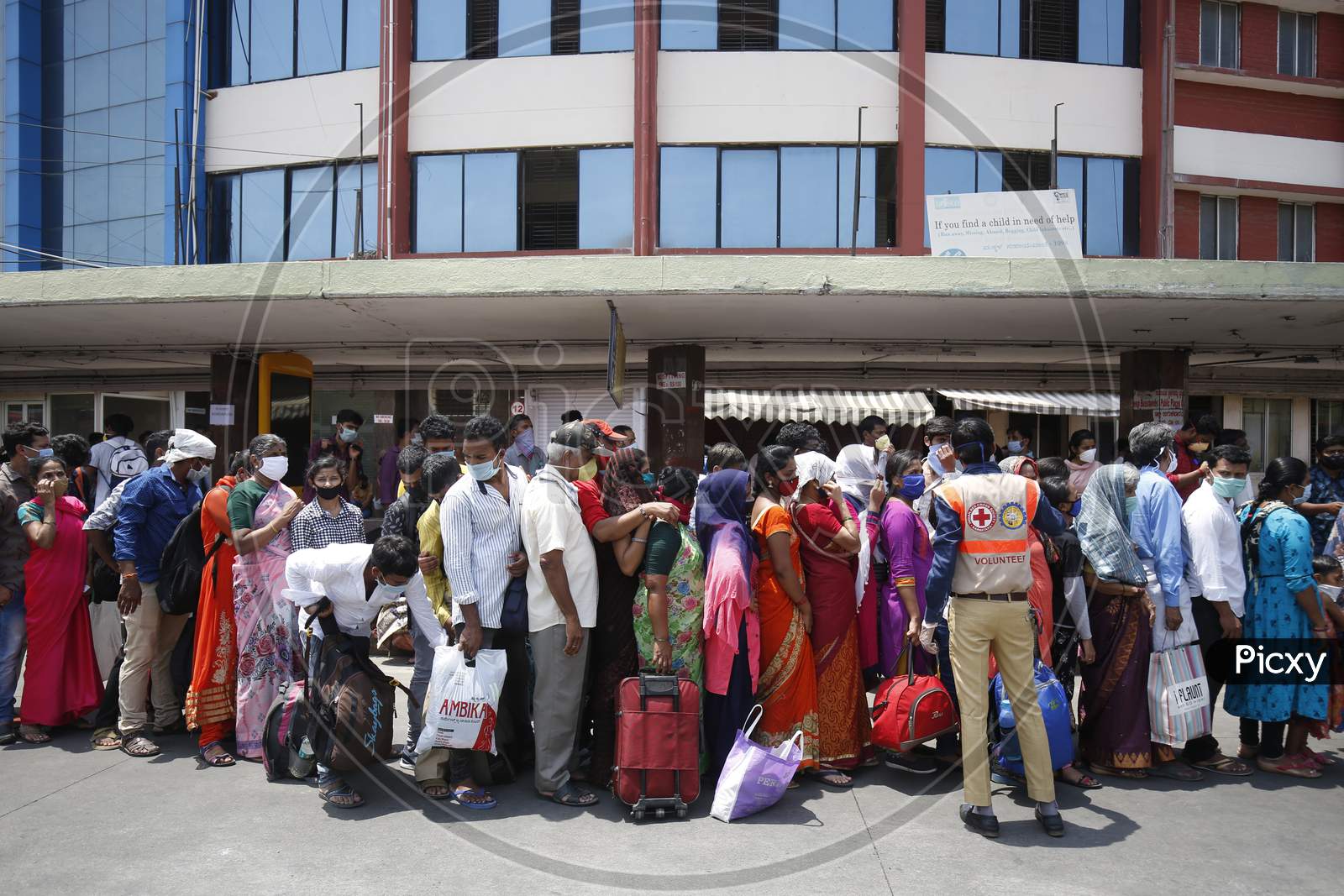 People wait in a queue to board public transport buses during the nationwide lockdown to stop the spread of Coronavirus (COVID-19) in Bangalore, India, May 03, 2020.