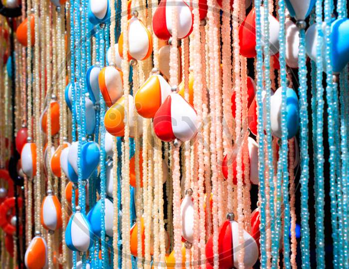 a bunch of strings woven with colorful wooden beads and hearts