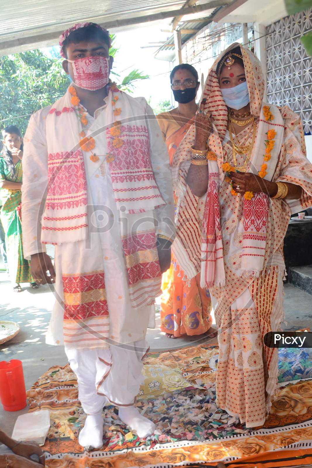 An Assamese  Groom (L) And A Bride Wearing Mask On Their  Wedding During The Ongoing Covid-19 Nationwide Lockdown At Bishnupur In Nagaon District Of Assam On May 03,2020.