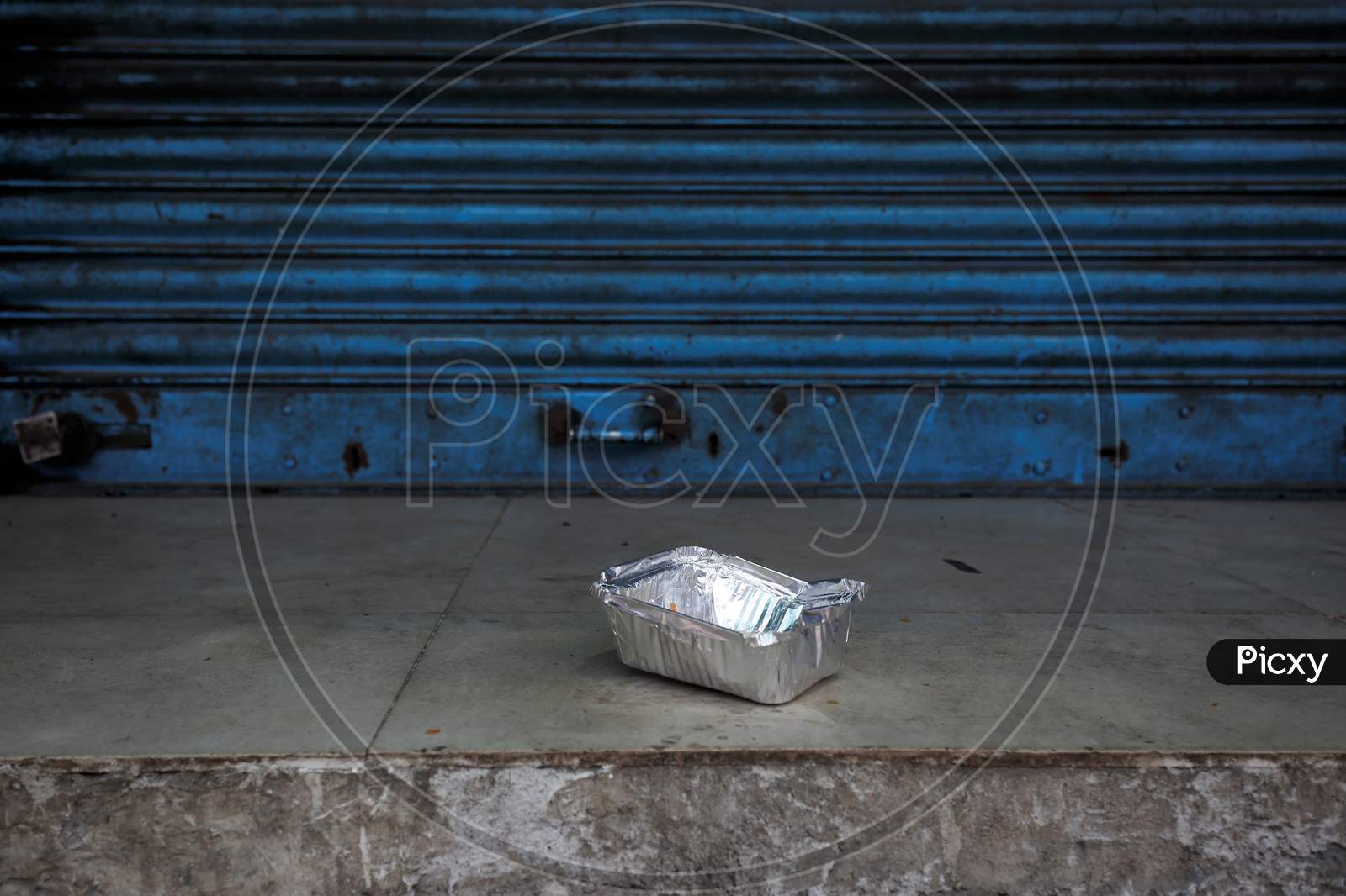 A box with partially eaten food is seen outside a shuttered shop during the nationwide lockdown to stop the spread of Coronavirus (COVID-19) in Bangalore, India, May 01, 2020.