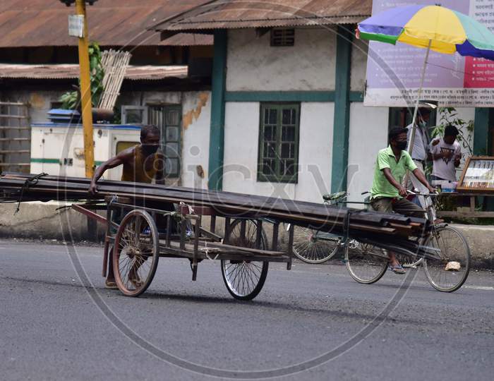 Nagaon : A Labour Carry Rod On His Cart  After Authorities Allowed   With Certain Restrictions, During The Ongoing Covid-19 Nationwide Lockdown In Nagaon District Of Assam On May 04,2020 ..Pix By Anuwar Hazarika