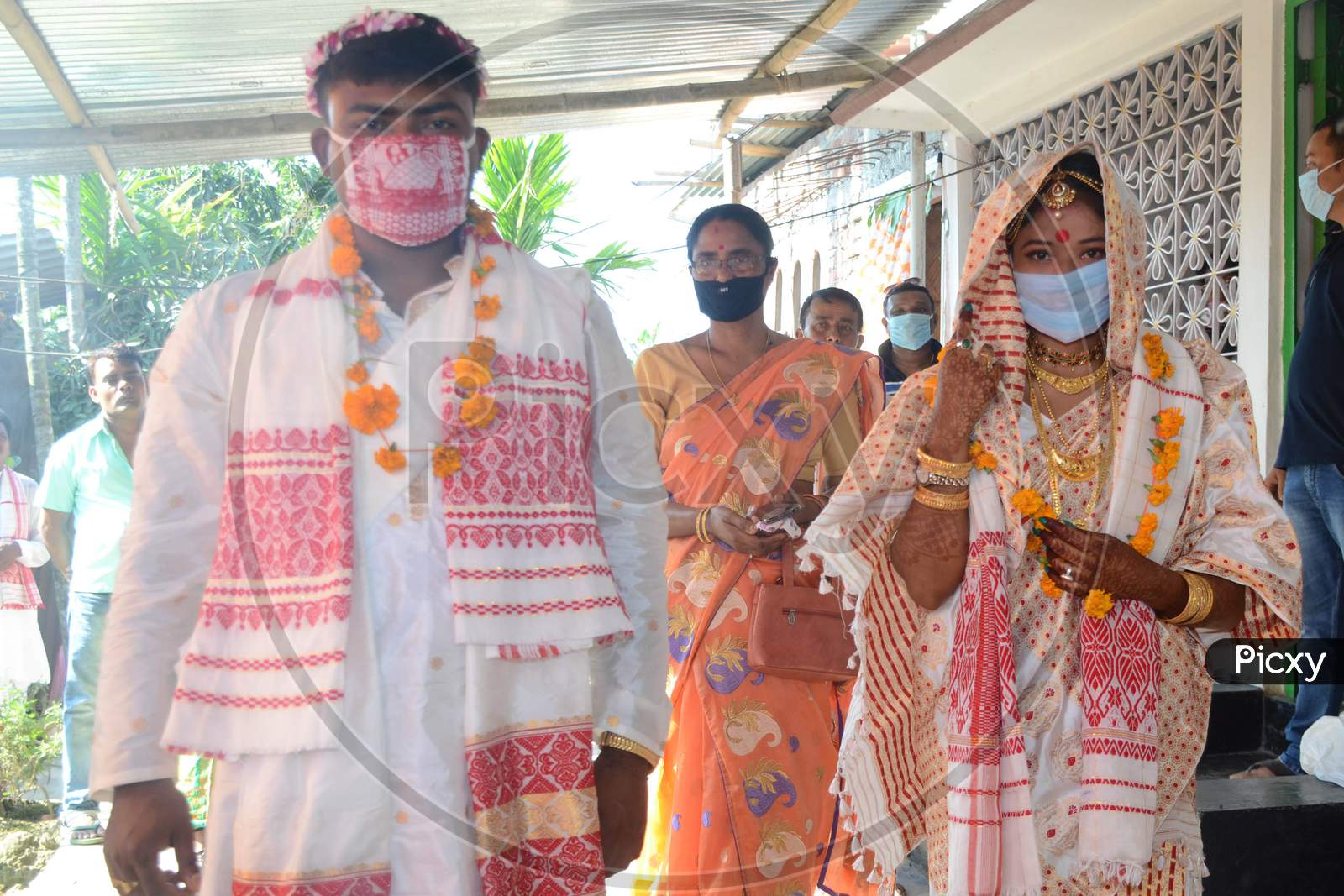A Assamese  Groom (L) And A Bride Along Wearing Mask On Their  Wedding During The Ongoing Covid-19 Nationwide Lockdown At Bishnupur In Nagaon District Of Assam On May 03,2020.